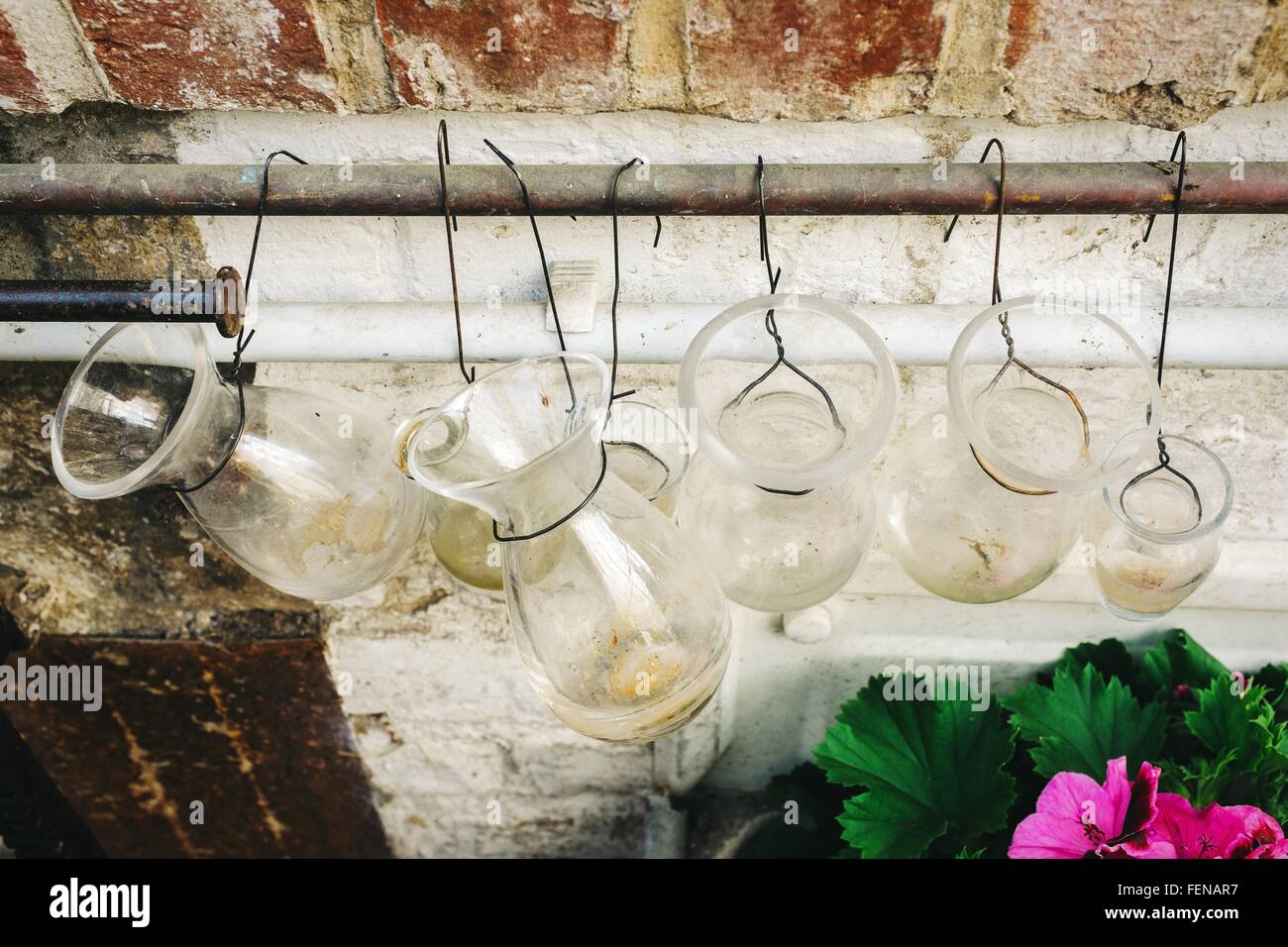 Glass Containers Hanging From Railing Against Wall Stock Photo Alamy