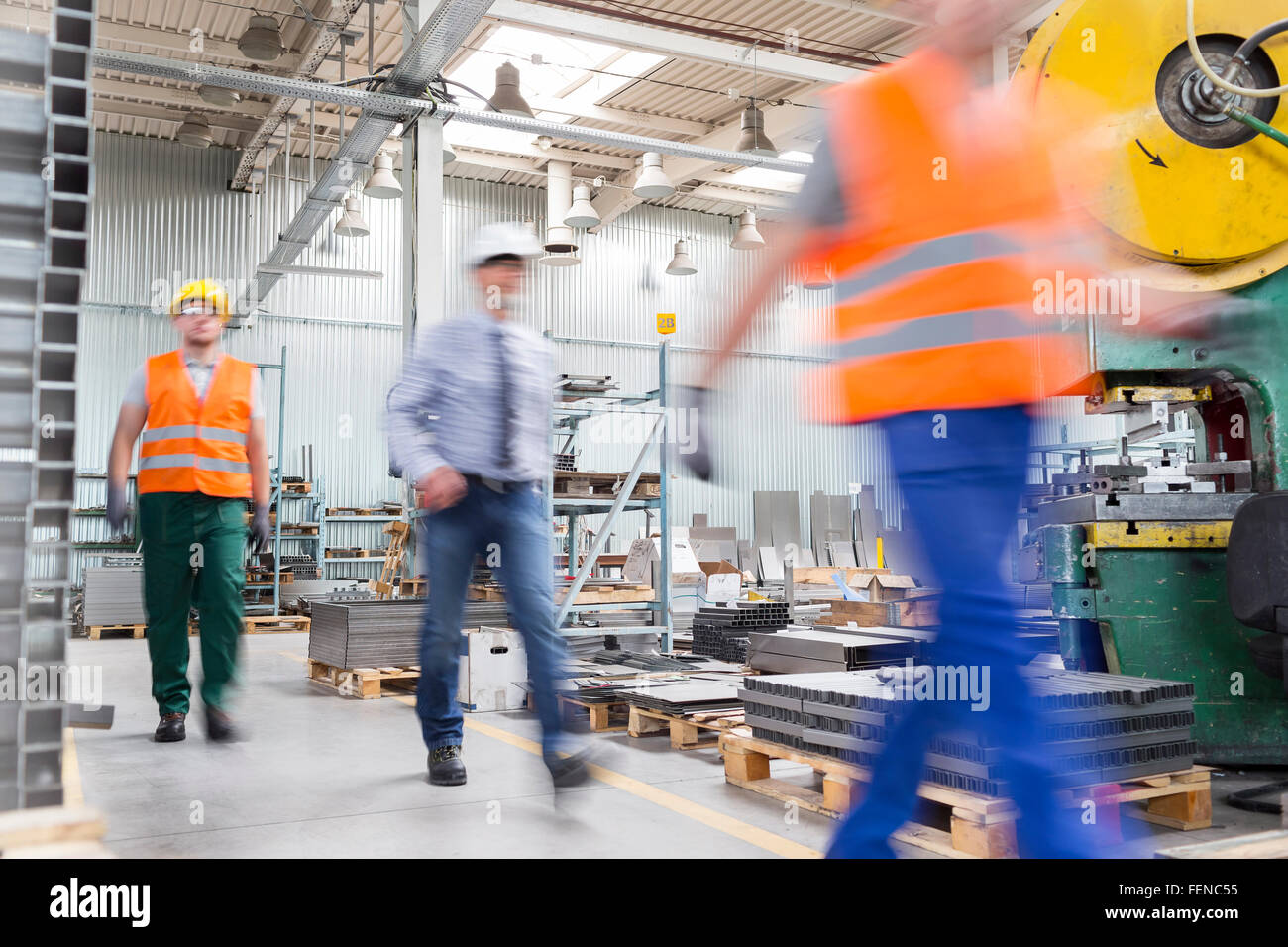 Engineer and works walking in factory Stock Photo