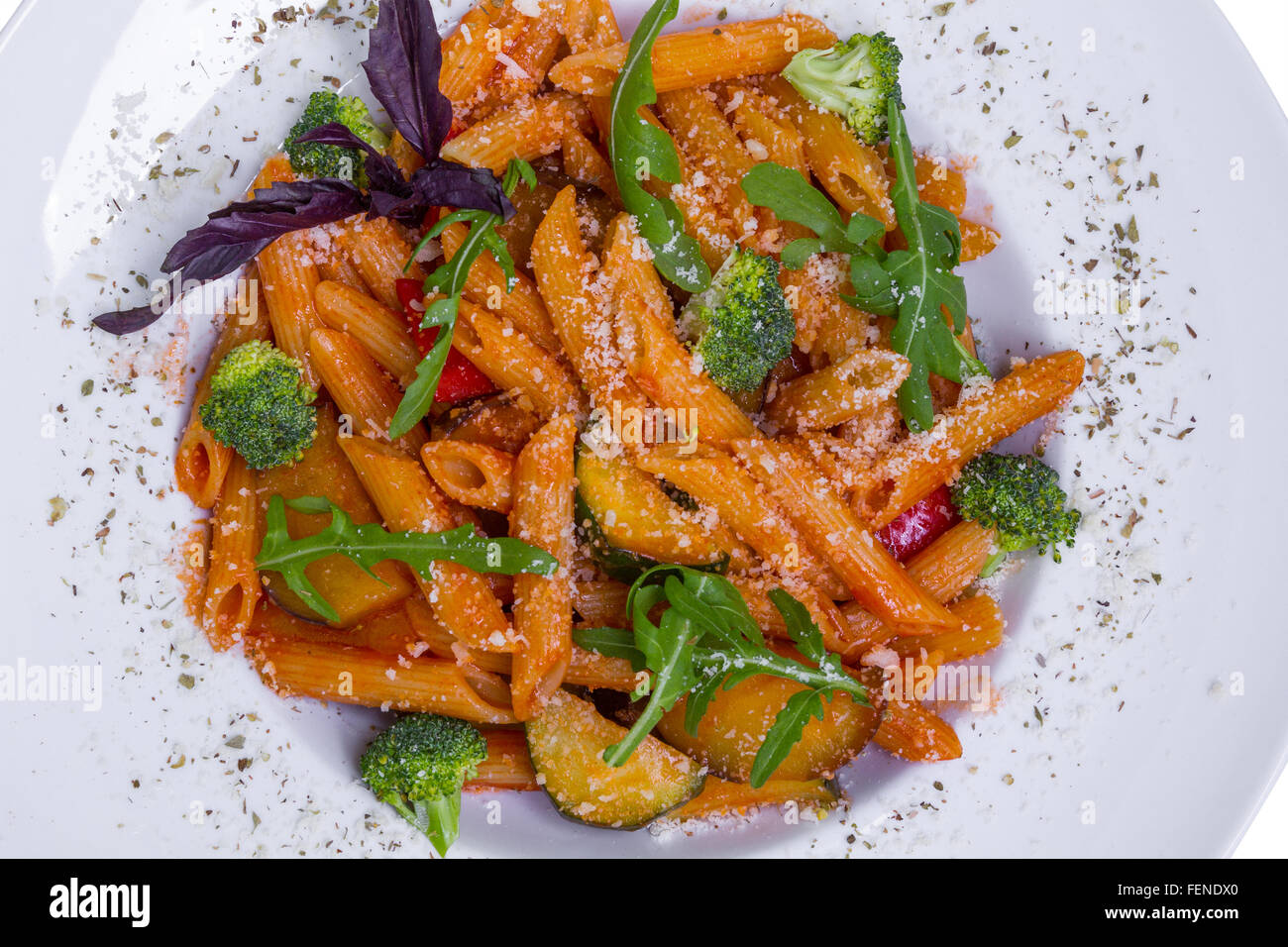 Red penne pasta with tomato sauce, broccoli, eggplant, paprika and parmesan  cheese Stock Photo - Alamy