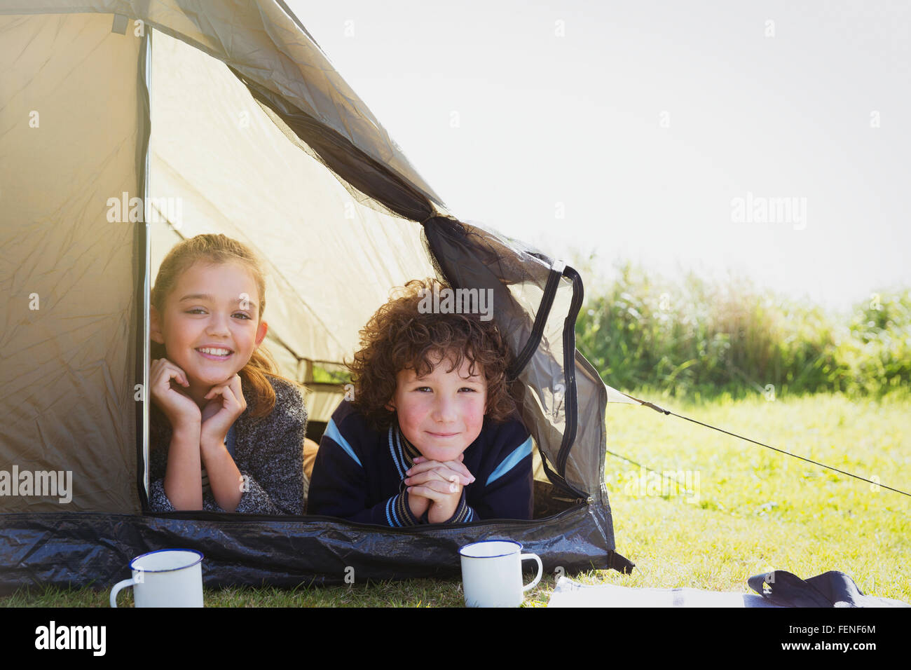 Portrait smiling brother and sister in tent Stock Photo