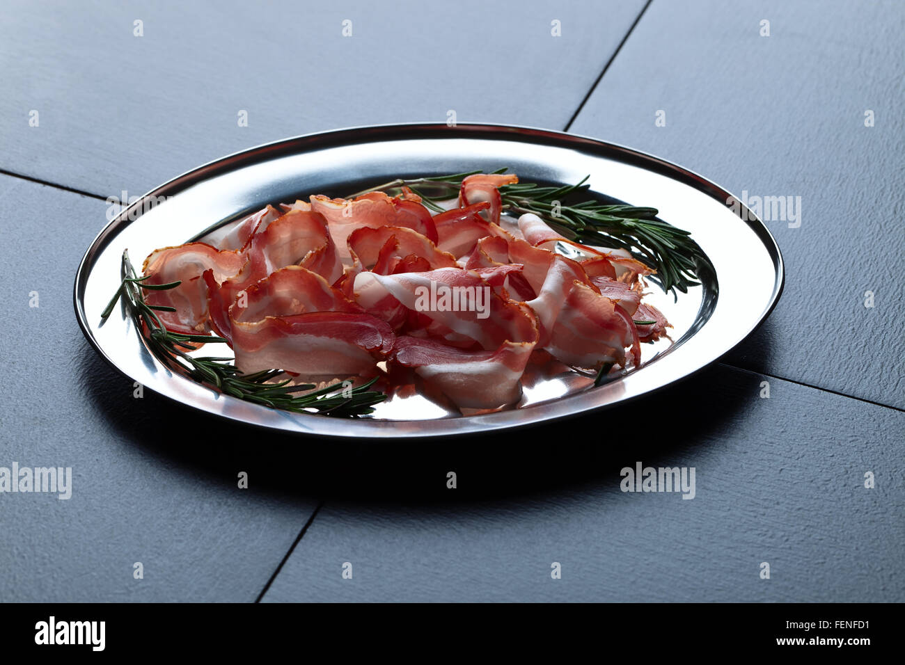 bacon with rosemary on a dark background Stock Photo - Alamy