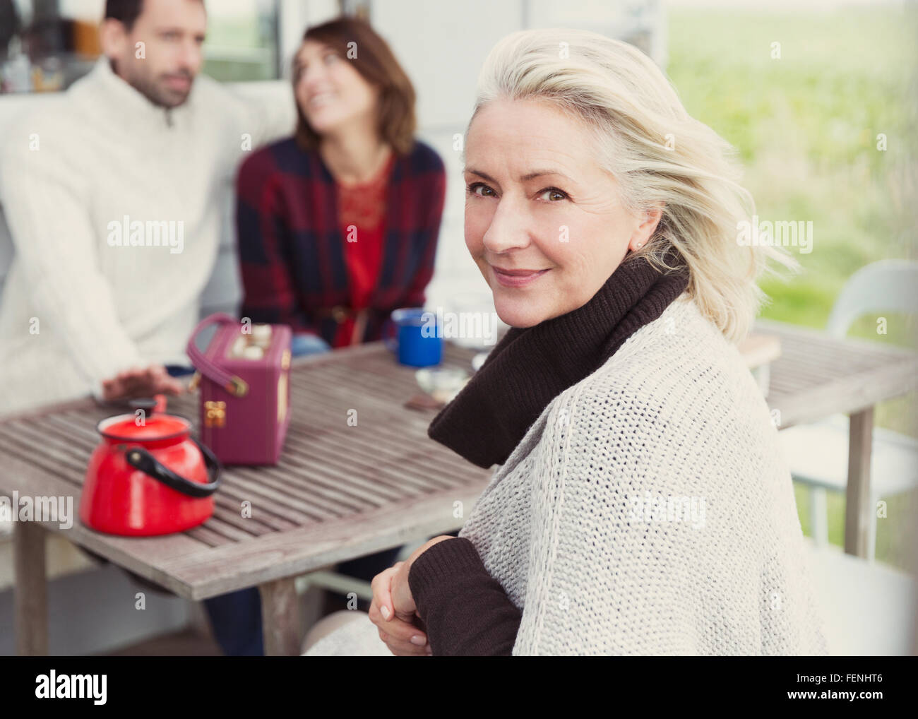 Portrait smiling senior woman at patio table Stock Photo - Alamy