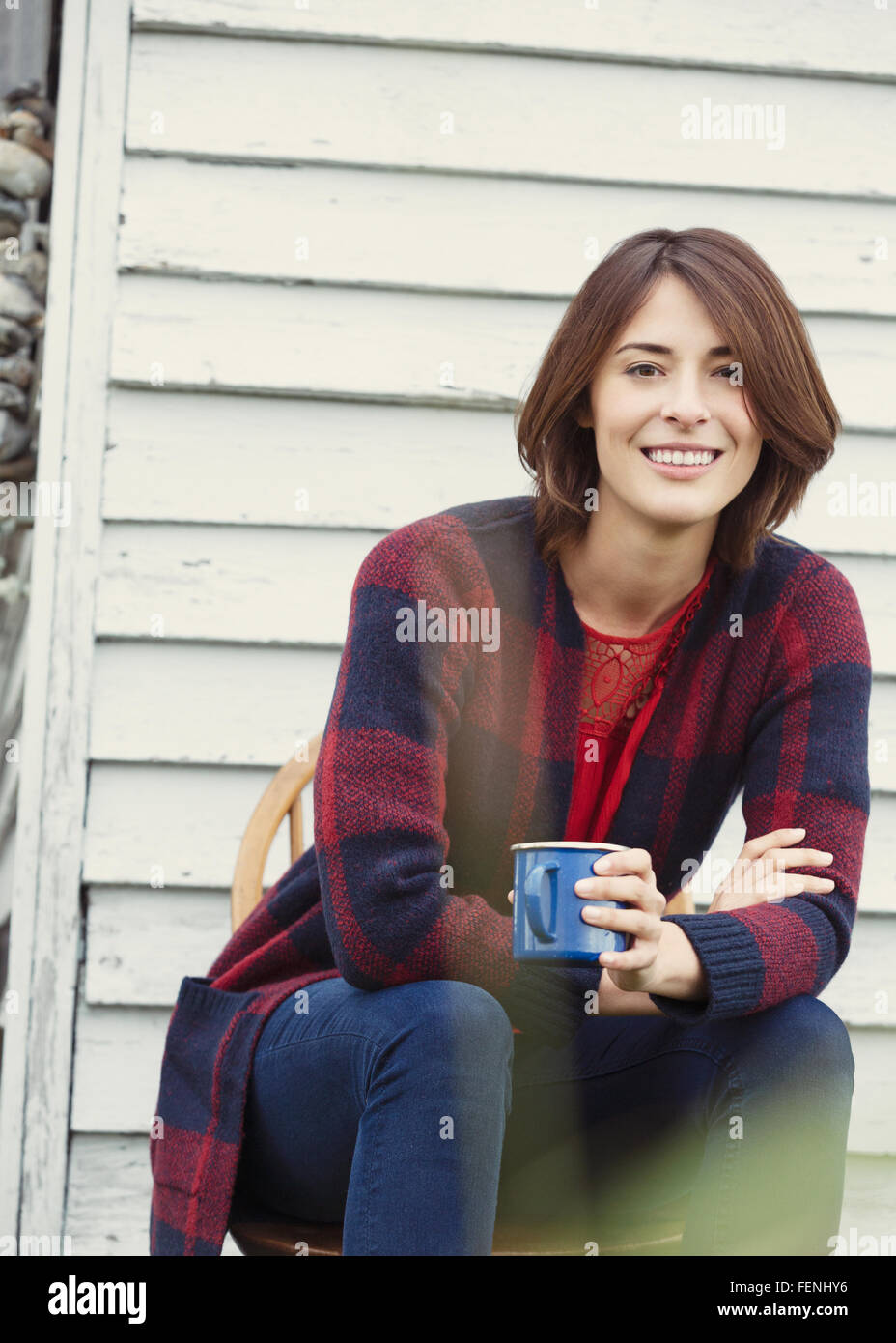 Portrait smiling brunette woman drinking coffee outdoors Stock Photo