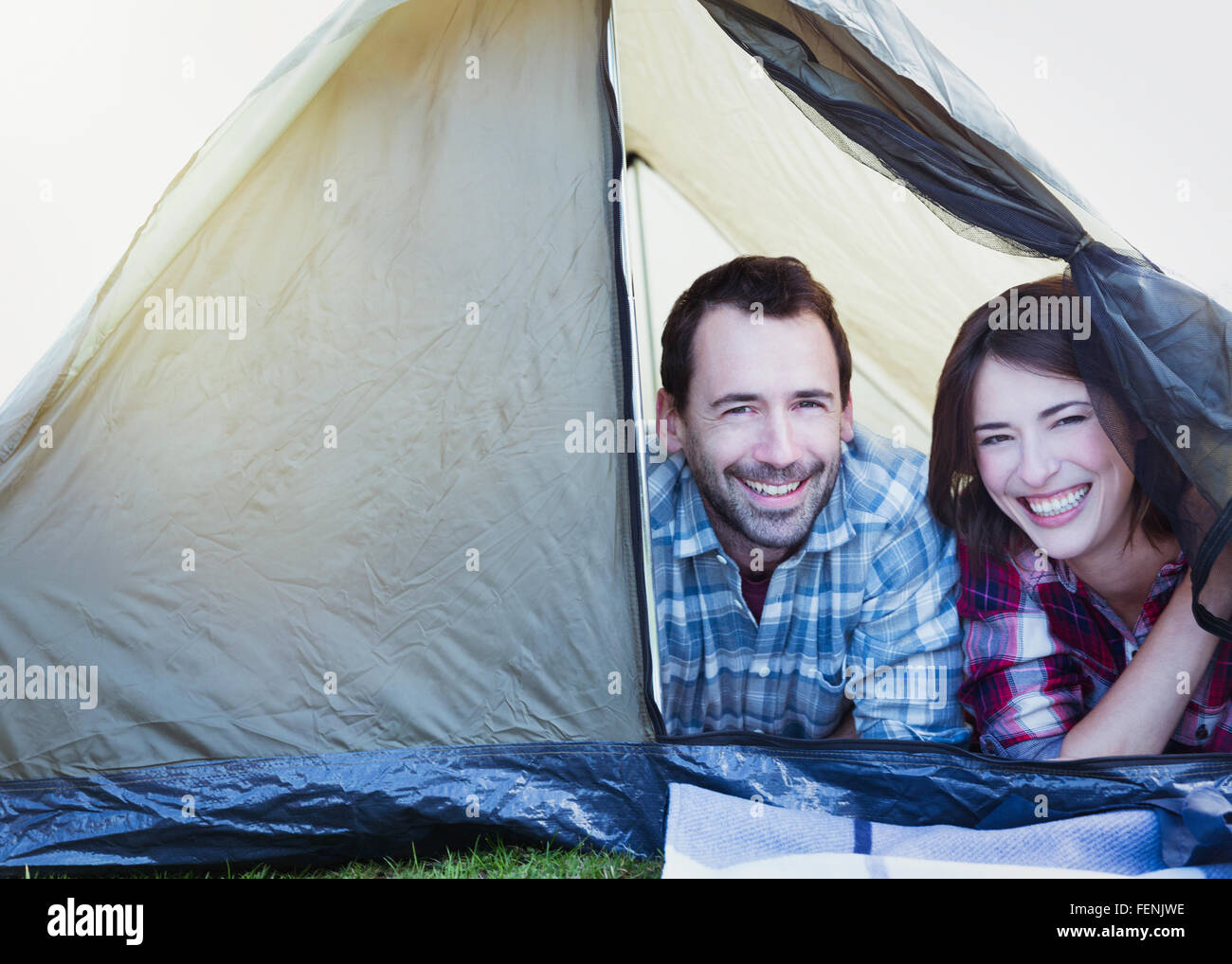 Portrait smiling couple in tent Stock Photo