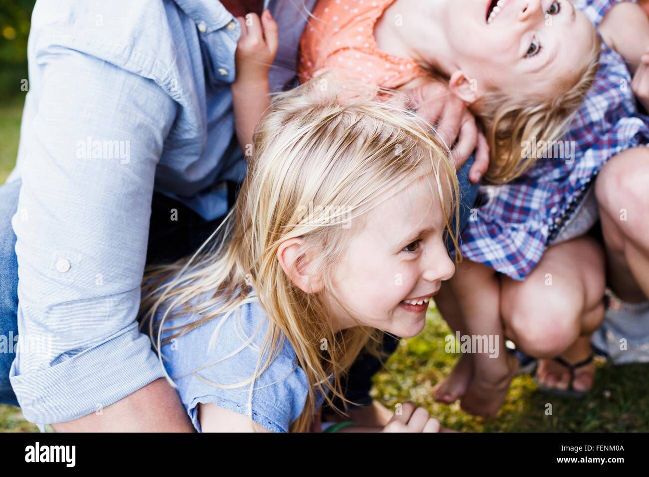 Cropped shot of parents and three young daughters in park Stock Photo