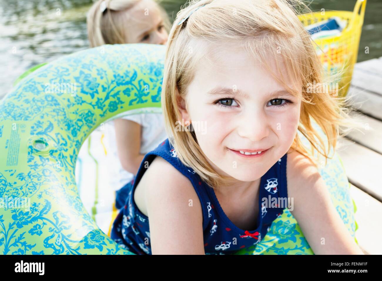 Portrait of cute girl playing with inflatable ring on pier at lake Starnberg, Bavaria, Germany Stock Photo