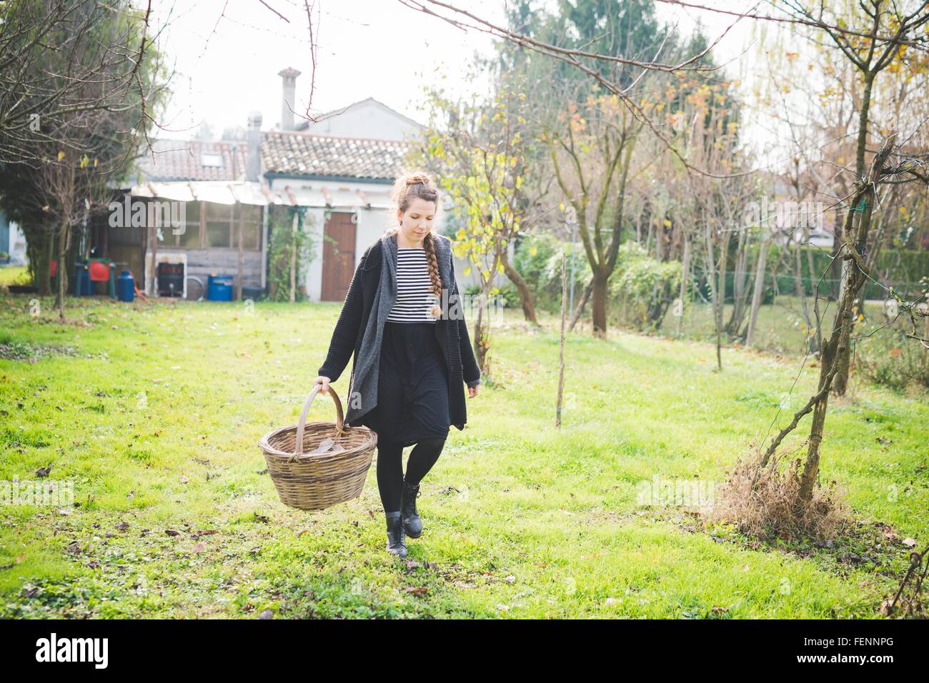 Woman carrying wicker basket full hi-res stock photography and images ...