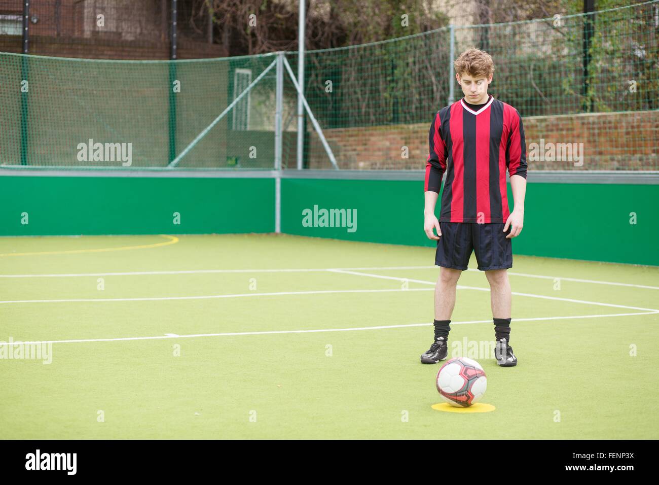 Young man on urban football pitch Stock Photo