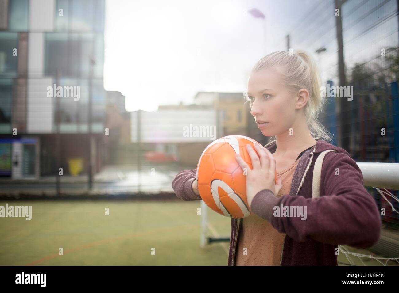 Young woman about to throw football Stock Photo Alamy