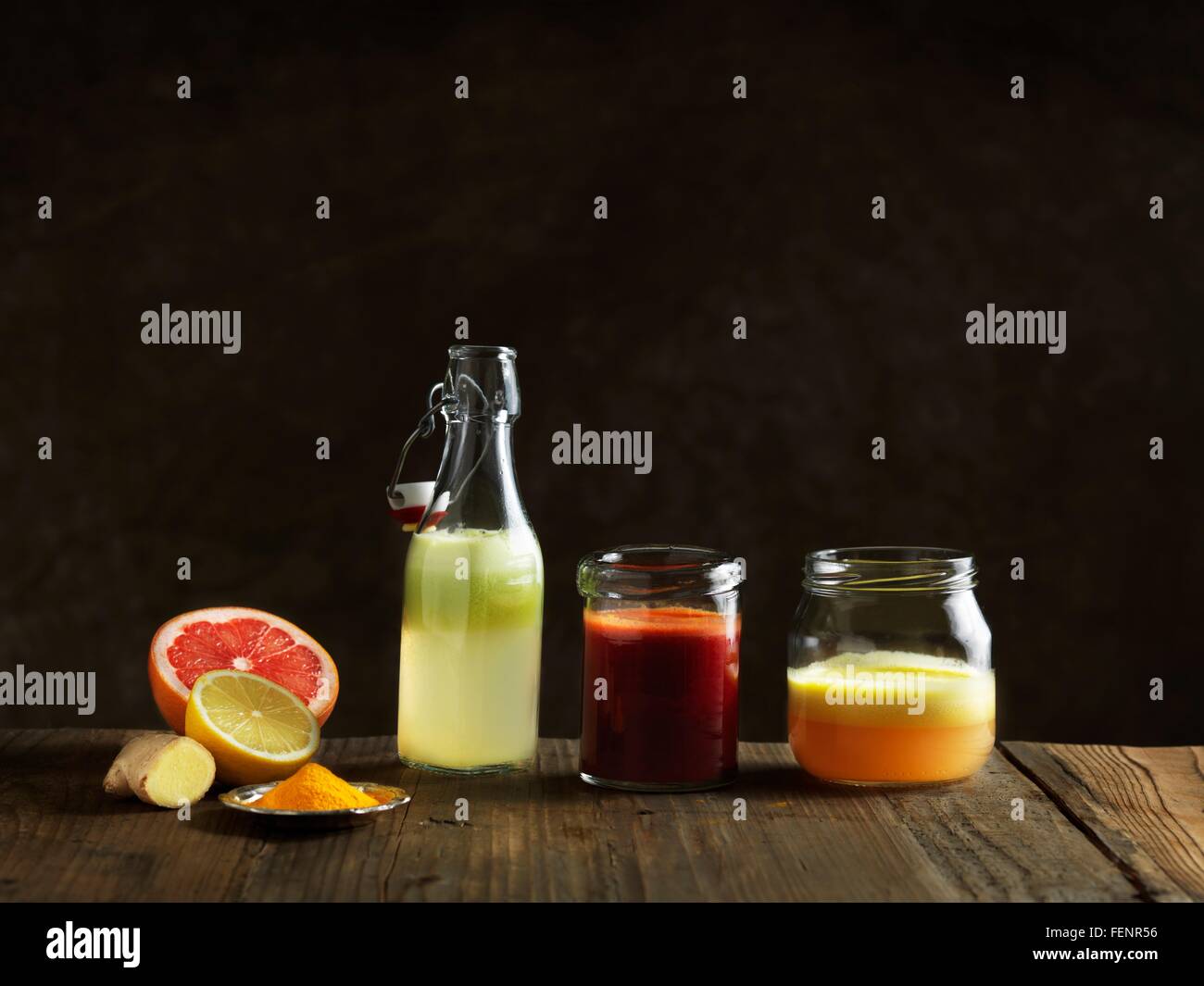 https://c8.alamy.com/comp/FENR56/raw-juices-in-glass-bottle-and-jars-dark-background-FENR56.jpg