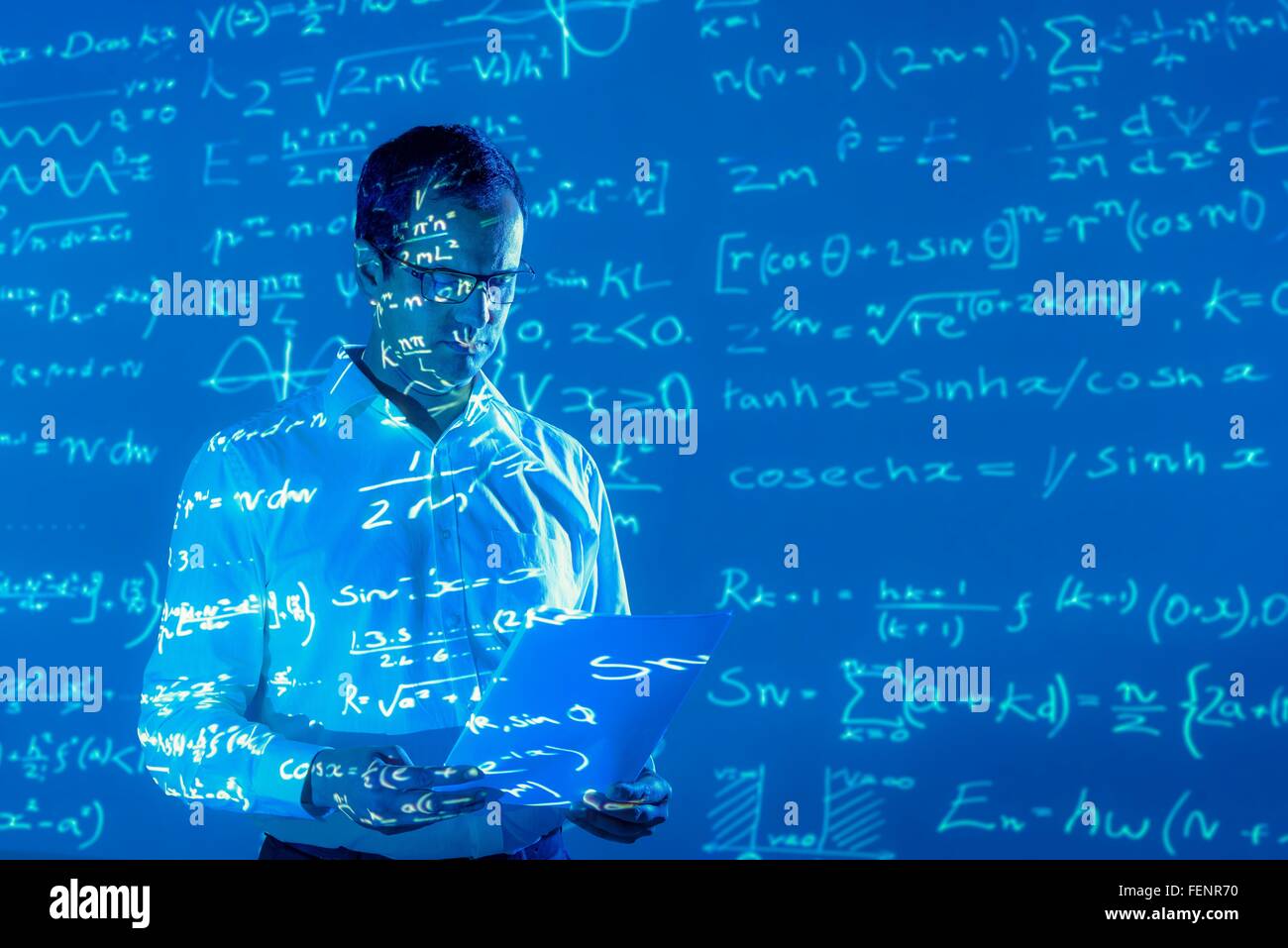 Scientist with projected mathematical data Stock Photo