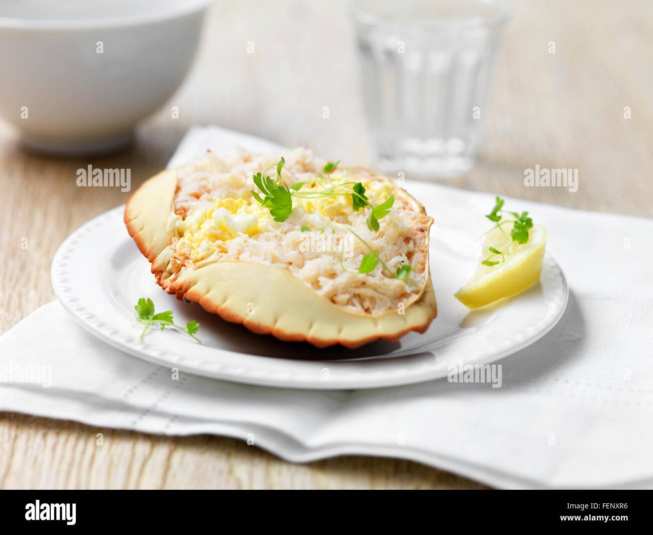 Orkney crab in shell with herbs and lemon wedge Stock Photo