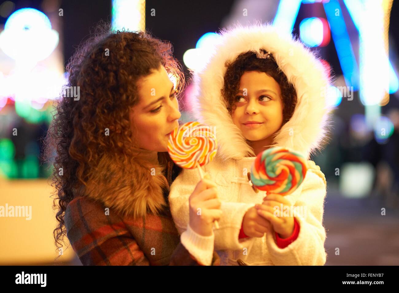 Mother and daughter enjoying lollipop Stock Photo