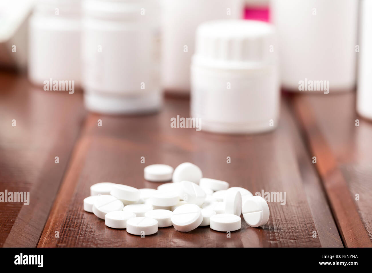 White pills and white plastic pill bottles Stock Photo