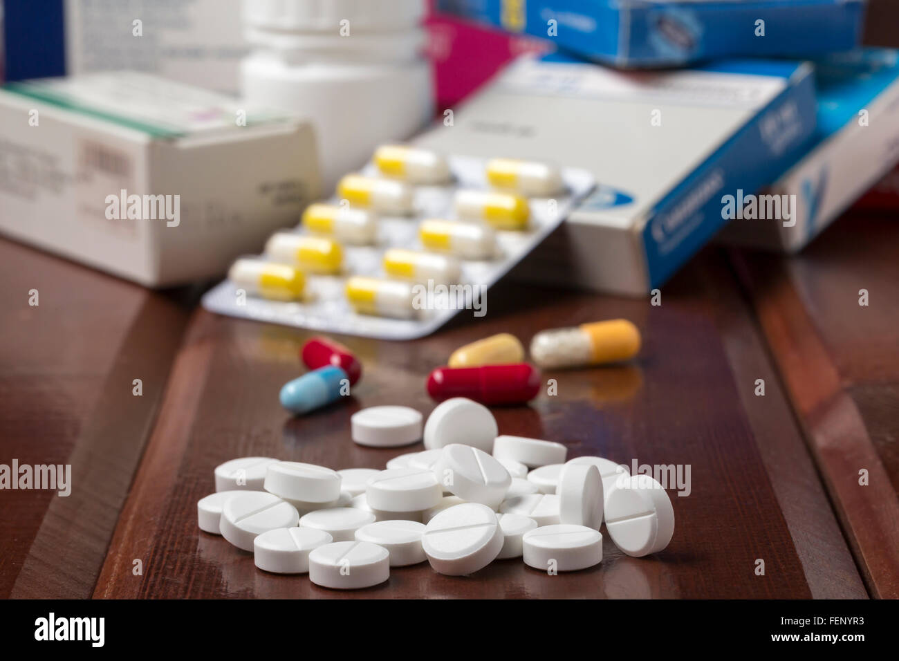Various colorful pills and pill bottles and boxes Stock Photo