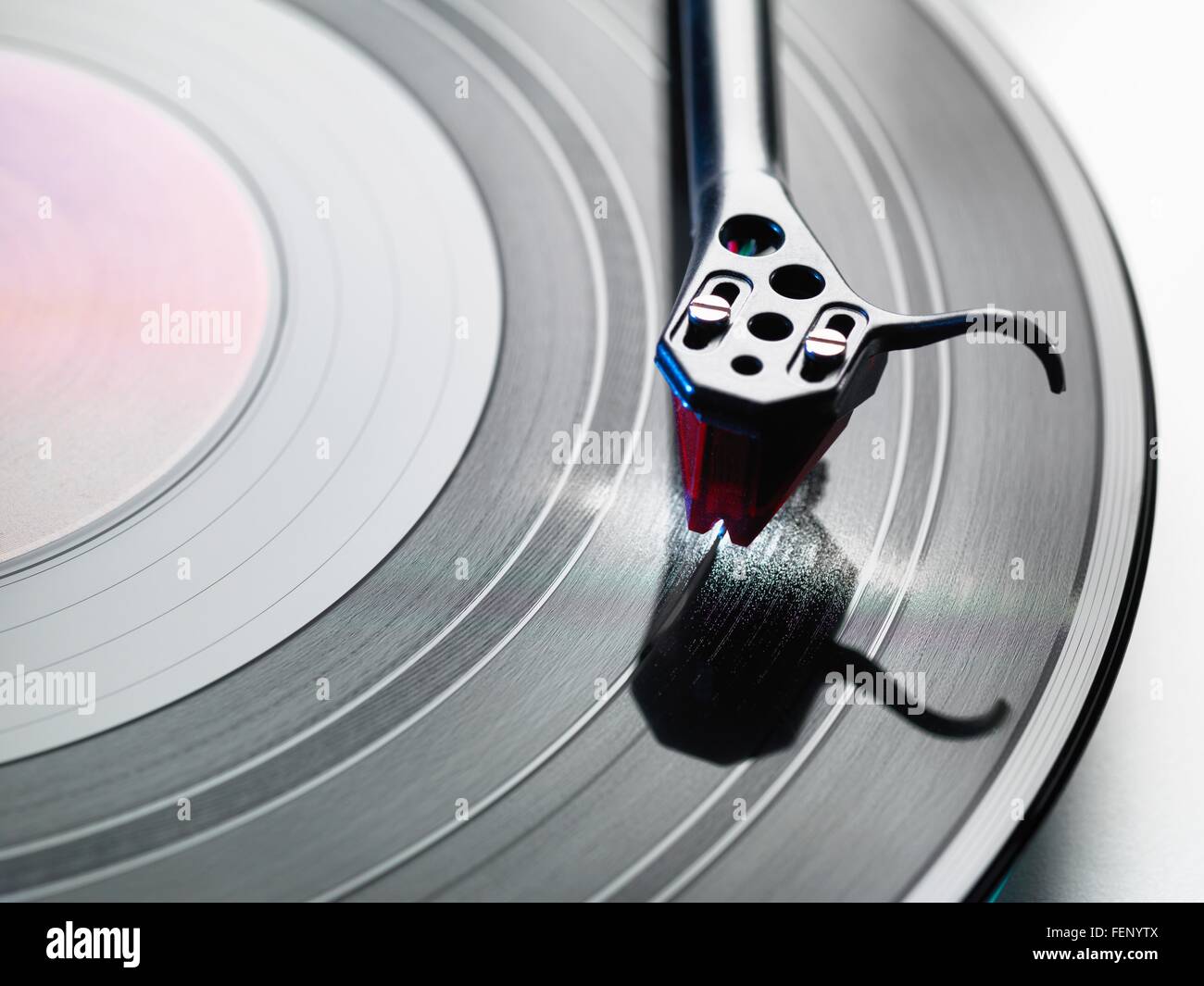 Overhead close up of turntable stylus playing a vinyl record Stock