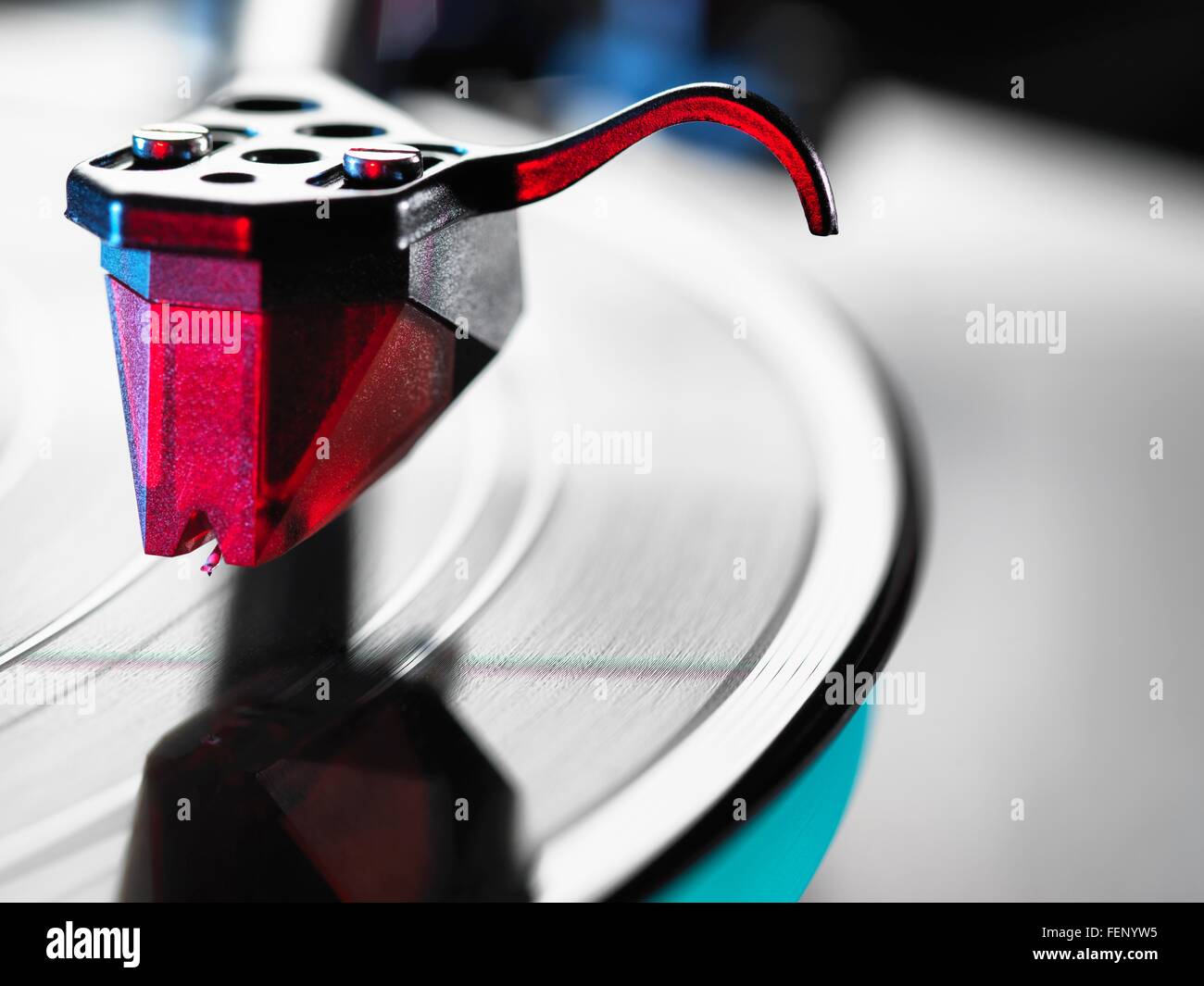 Close up of red turntable stylus playing a vinyl record Stock Photo
