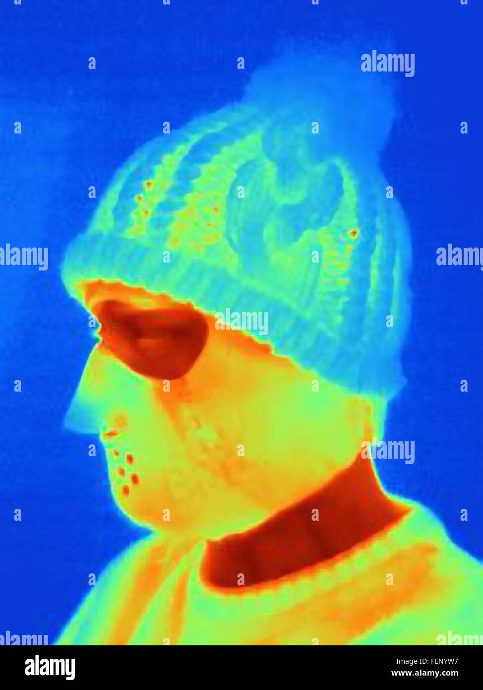 Thermal image of young man wearing threatening mask and knit hat Stock Photo