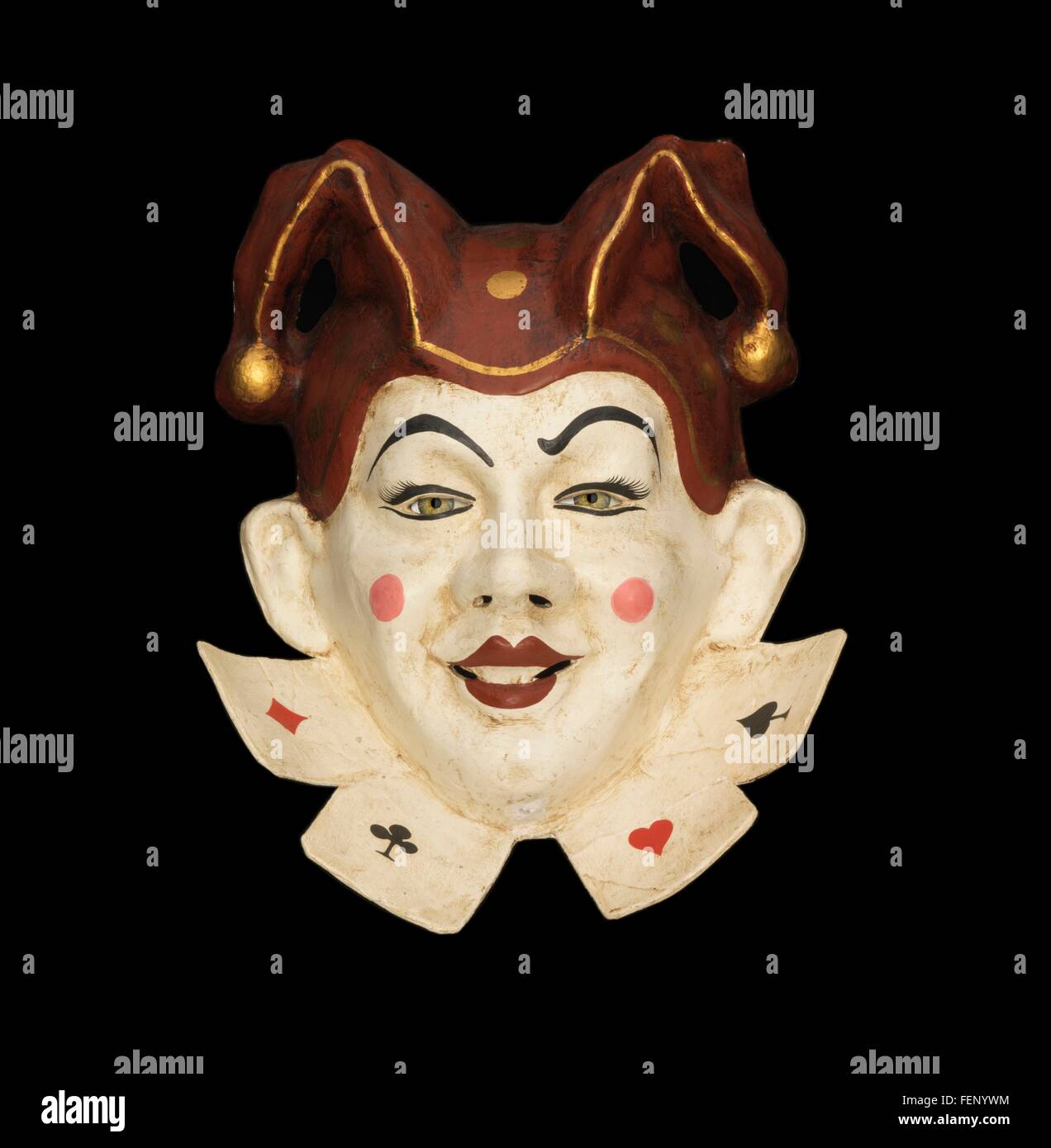 Smiling venetian jester face mask with jester hat on black background Stock Photo