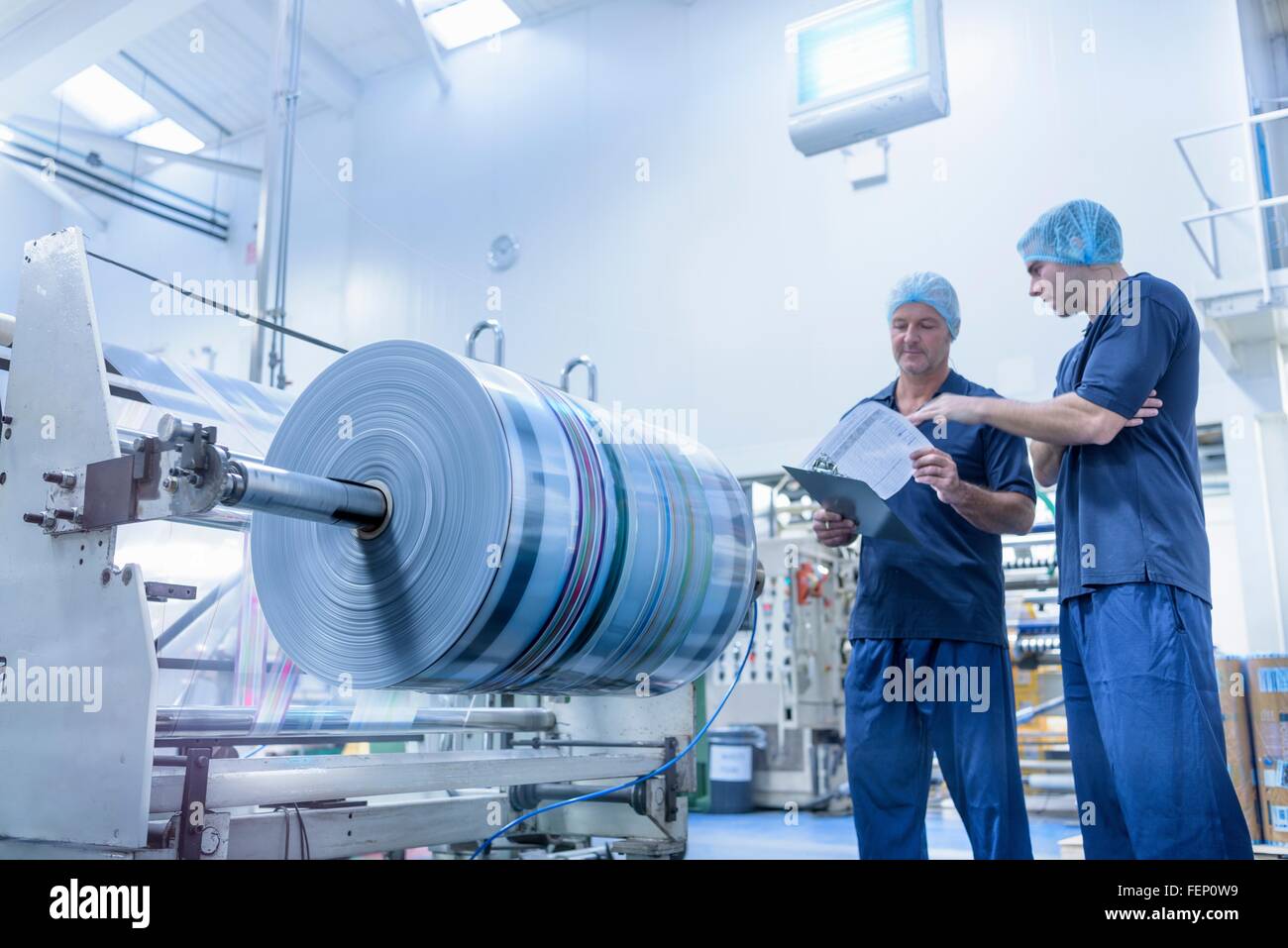 Workers in discussion in food packaging printing factory Stock Photo