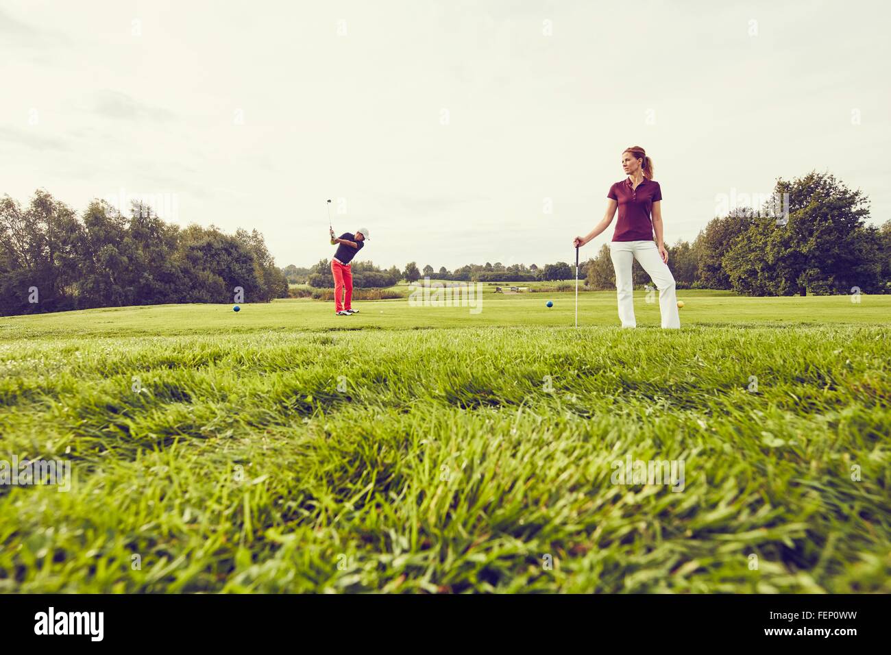Golfers playing golf on course, Korschenbroich, Dusseldorf, Germany Stock Photo