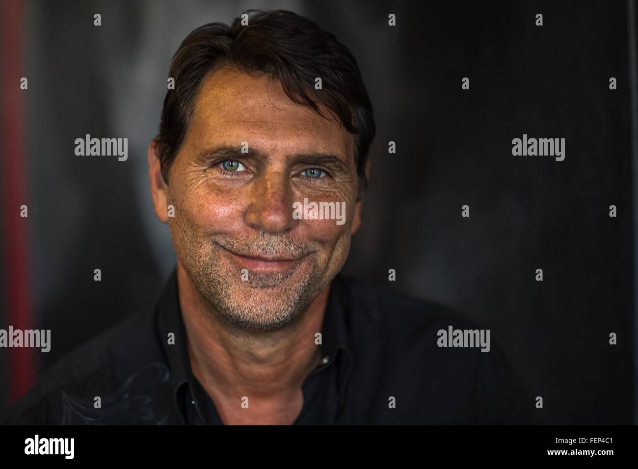 Portrait of tanned mature man looking at camera smiling Stock Photo