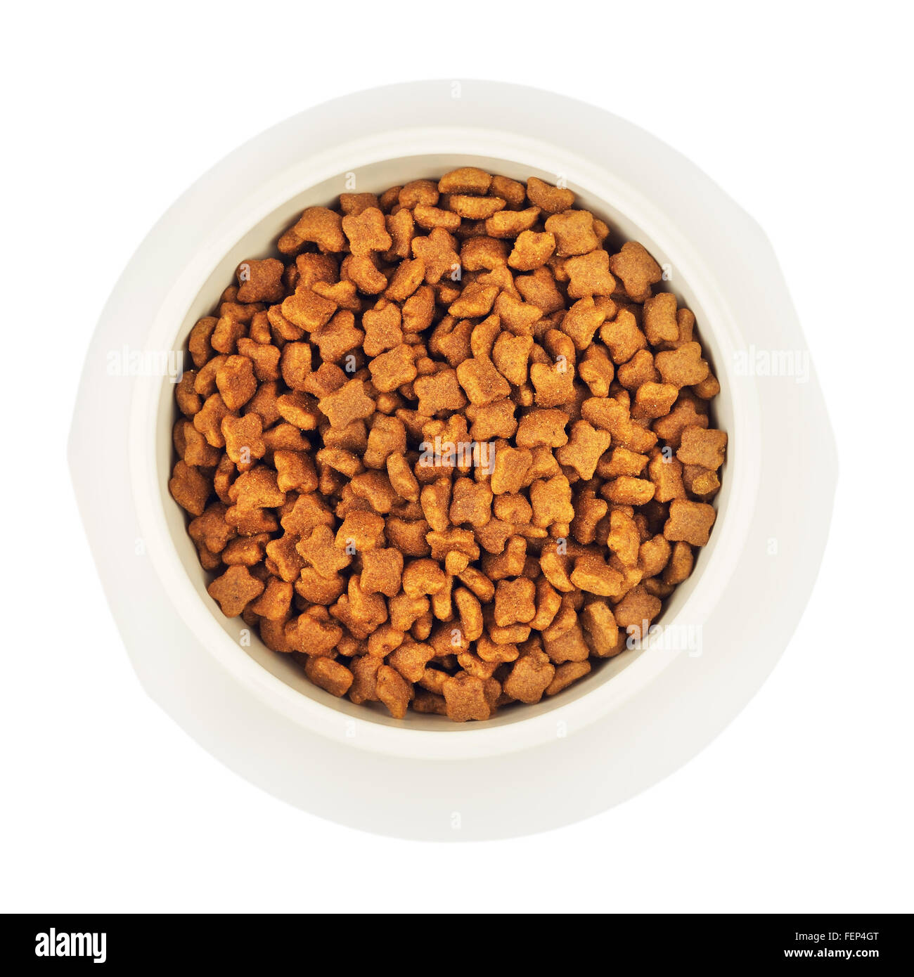 dry cat food in white bowl, isolated top view Stock Photo