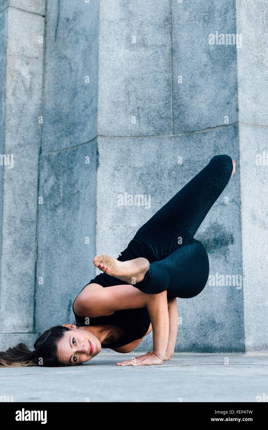 Woman in Arm Balance pose (Eka Pada Koundinyasana) Stock Photo