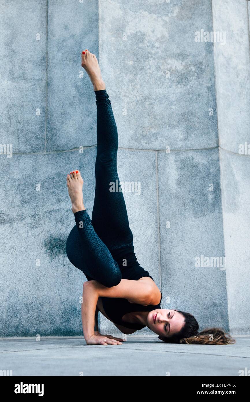 Woman in Arm Balance pose (Eka Pada Koundinyasana) Stock Photo