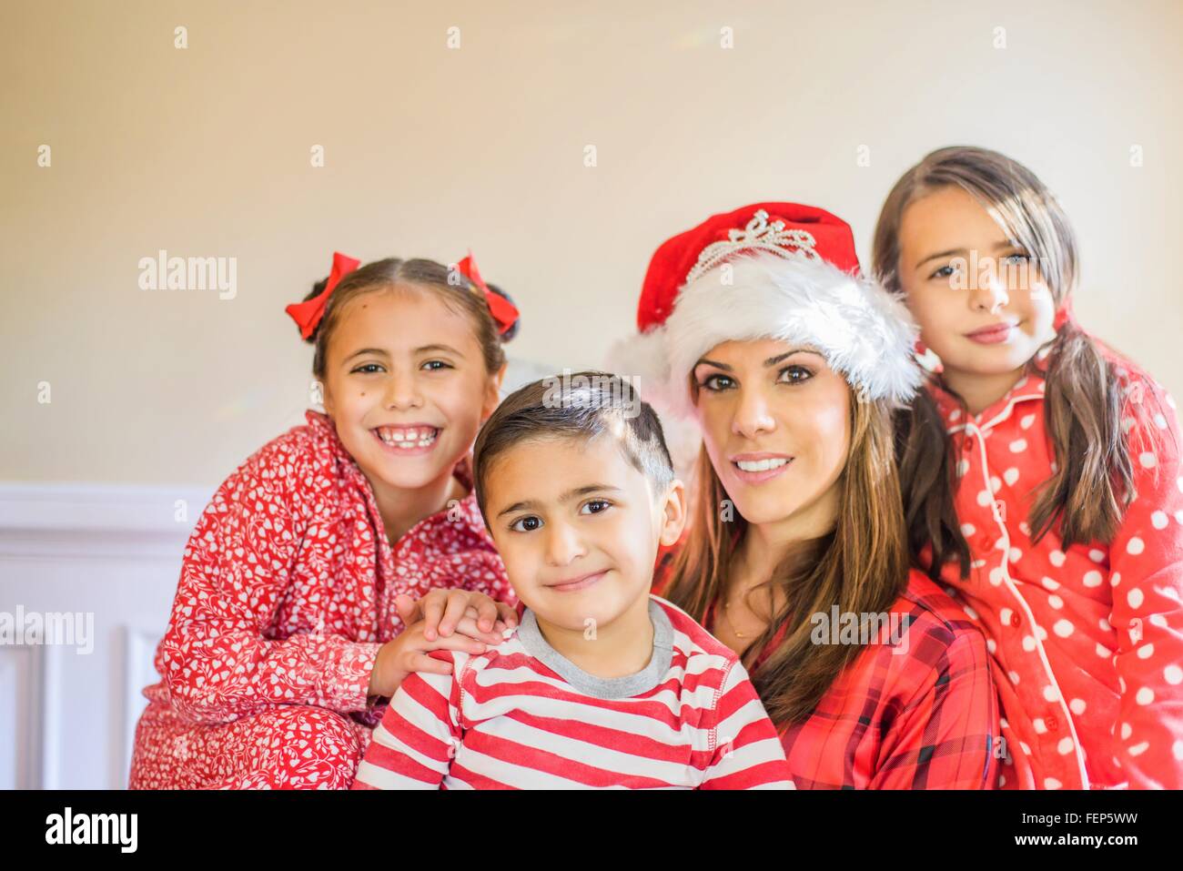 Portrait of mother and children, mother wearing festive hat Stock Photo