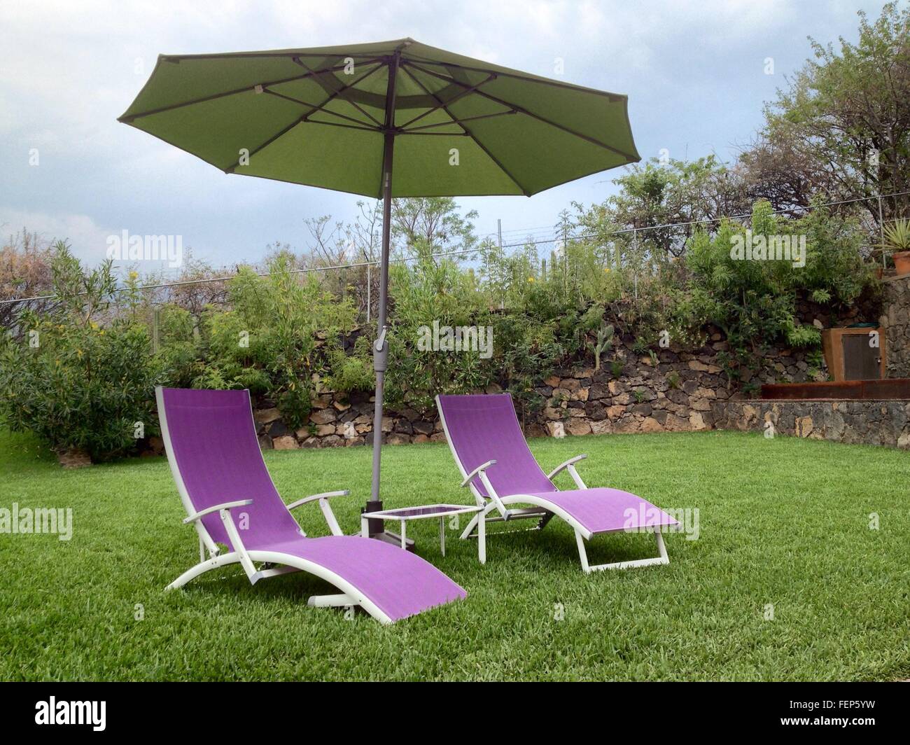 Patio Umbrella With Lounge Chair In Field Stock Photo Alamy