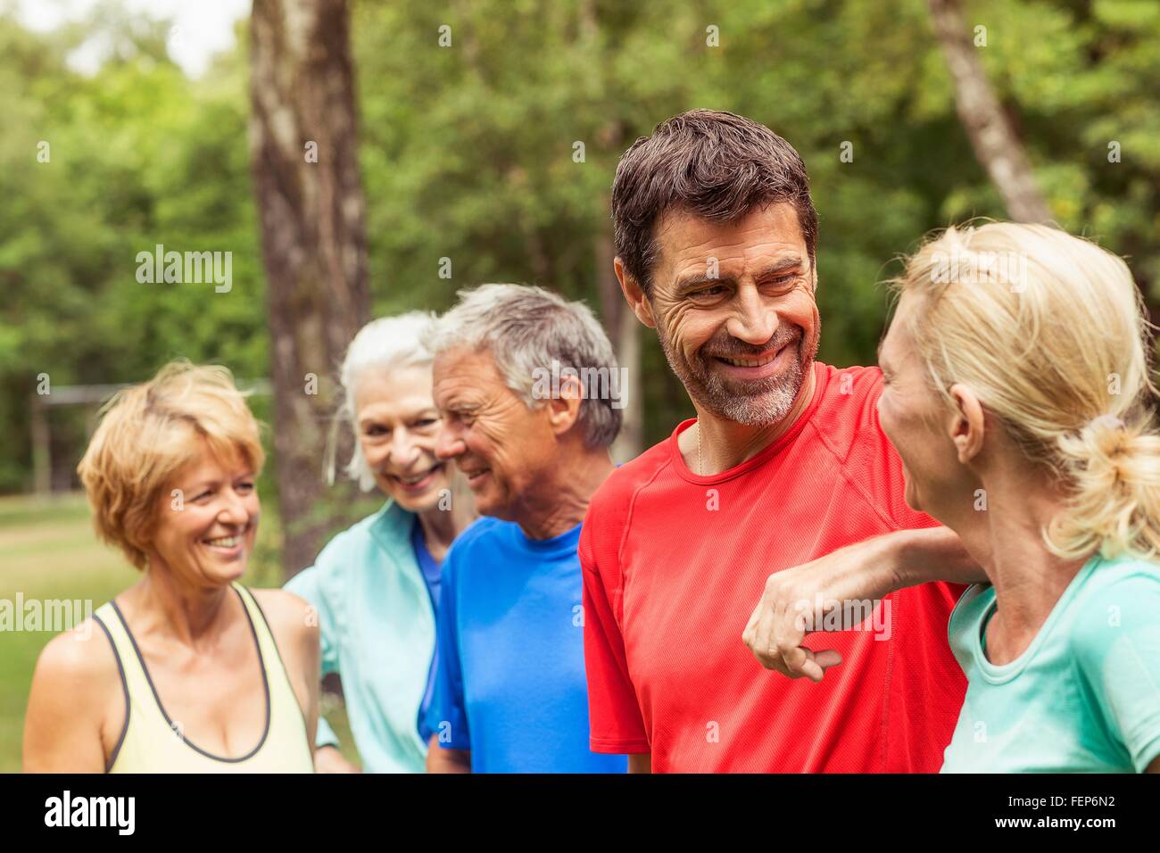 Group of adults outdoors, wearing sports clothing, smiling Stock Photo