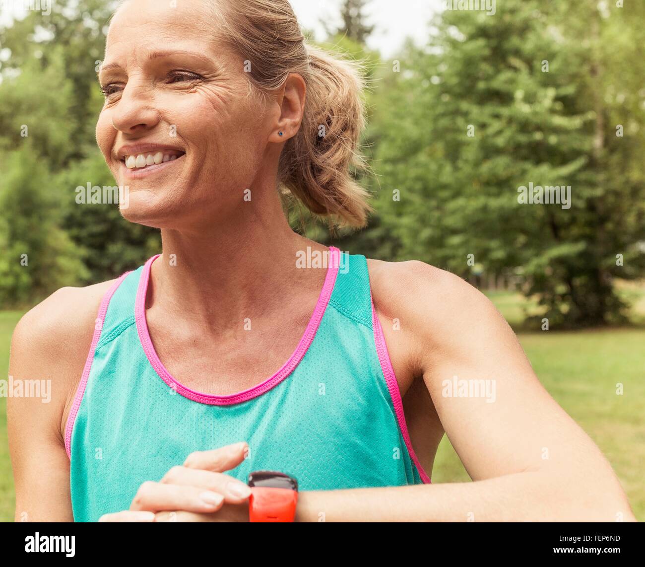 Mature woman, working out, outdoors, smiling Stock Photo