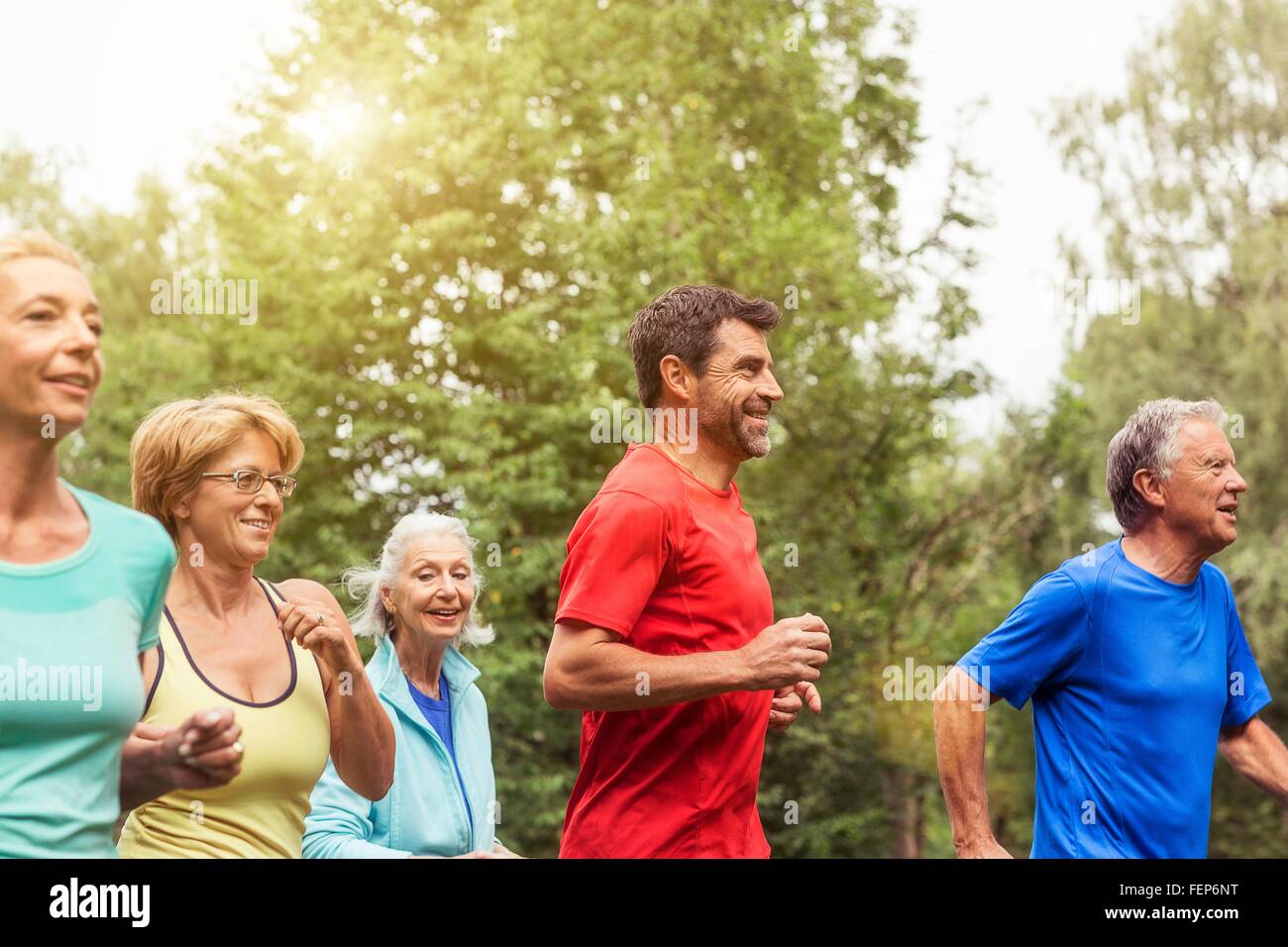 Group of adults running outdoors Stock Photo