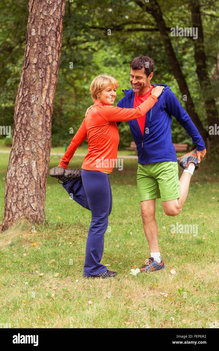 Couple exercising, stretching, outdoors Stock Photo