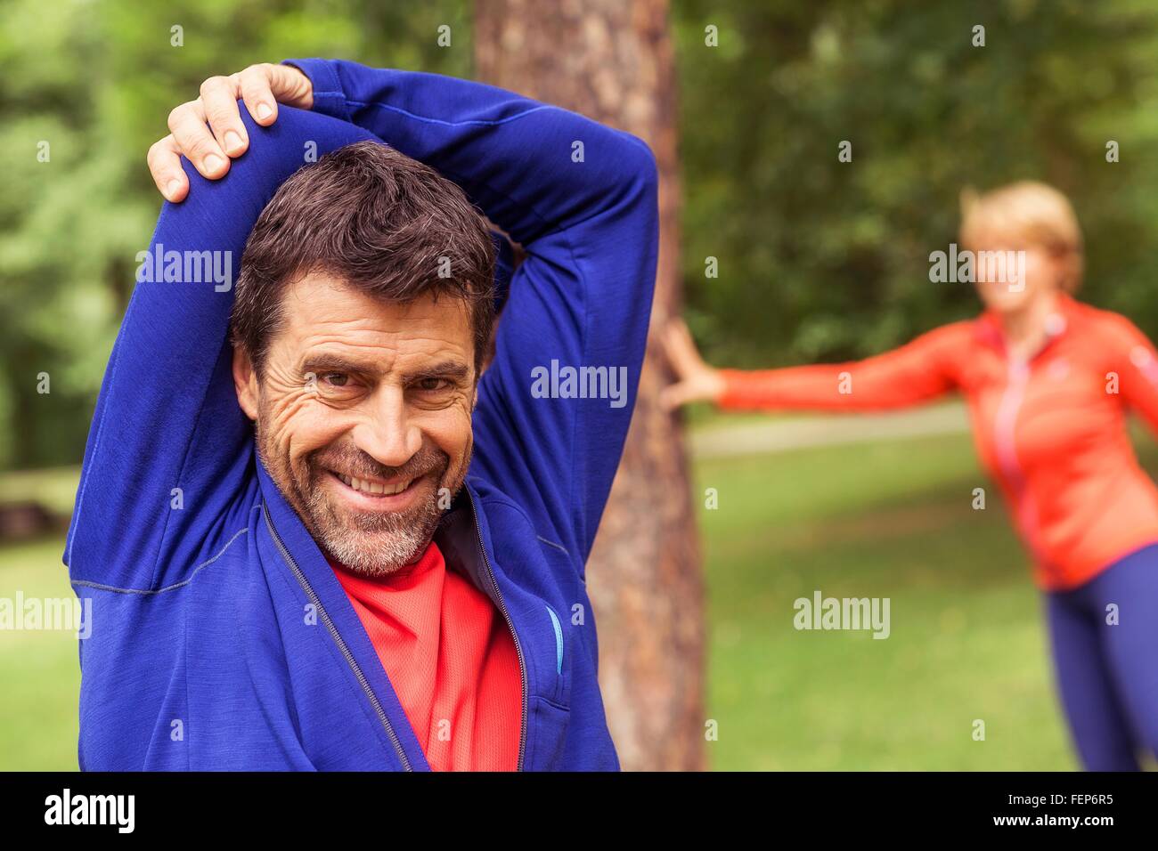 Couple exercising, stretching, outdoors Stock Photo