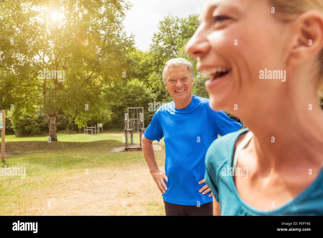 Mature woman and senior man beside assault course, smiling Stock Photo
