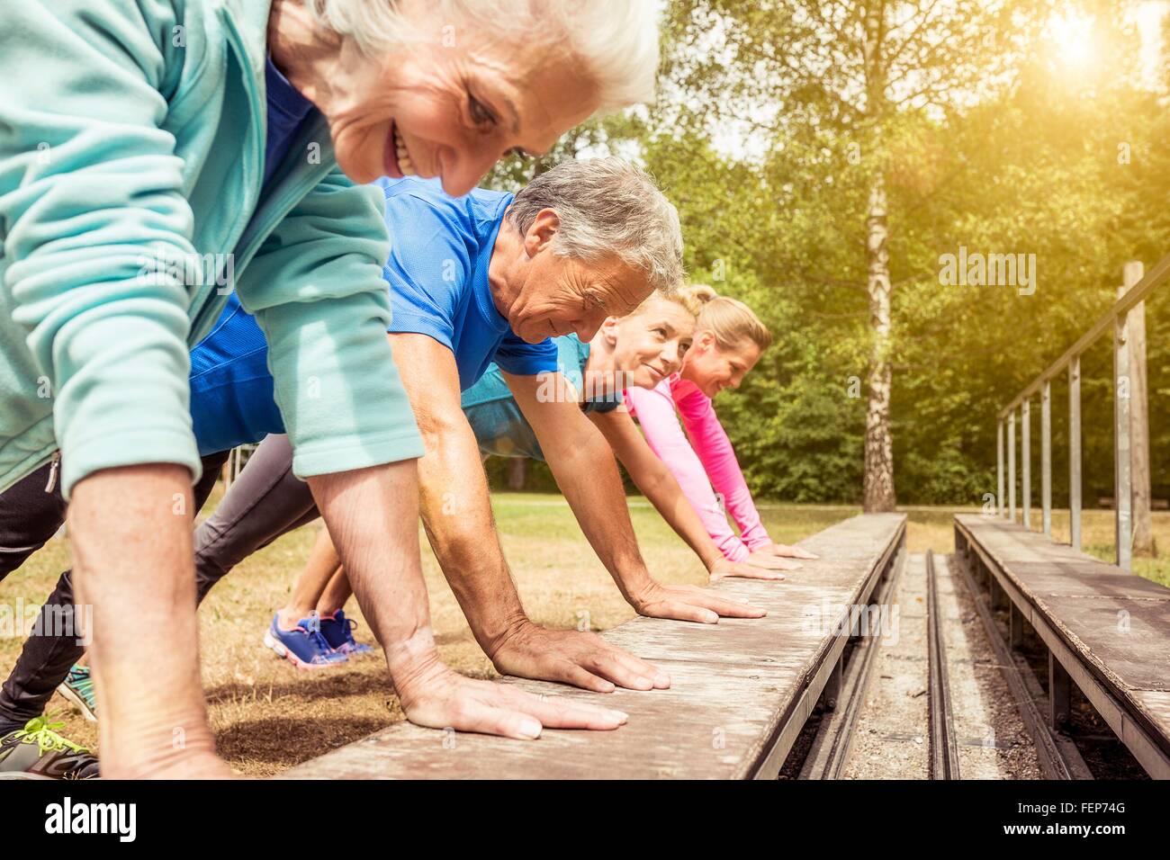 Group of adults exercising outdoors Stock Photo