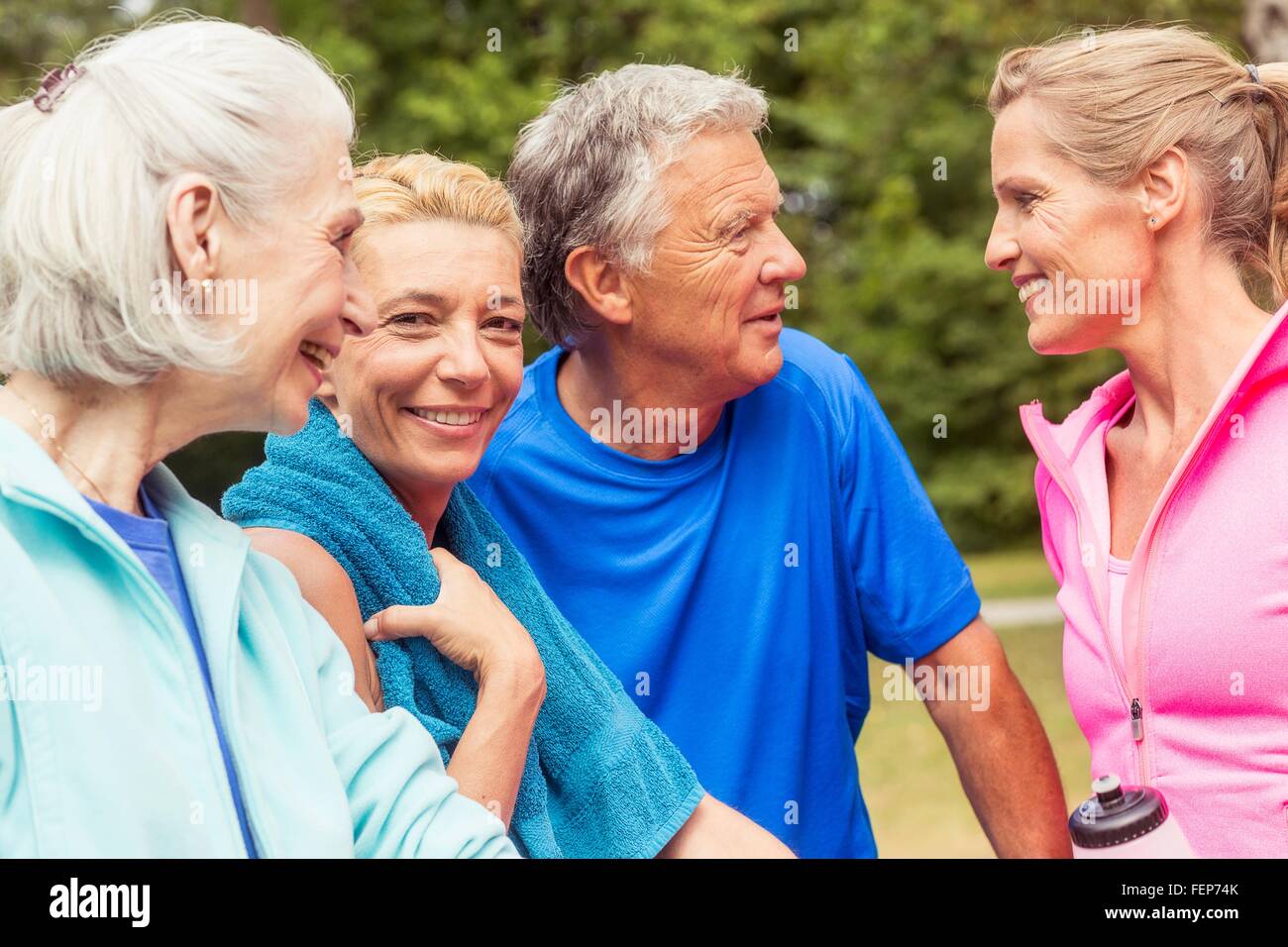 Group of adults taking a break from exercise, outdoors, smiling Stock Photo