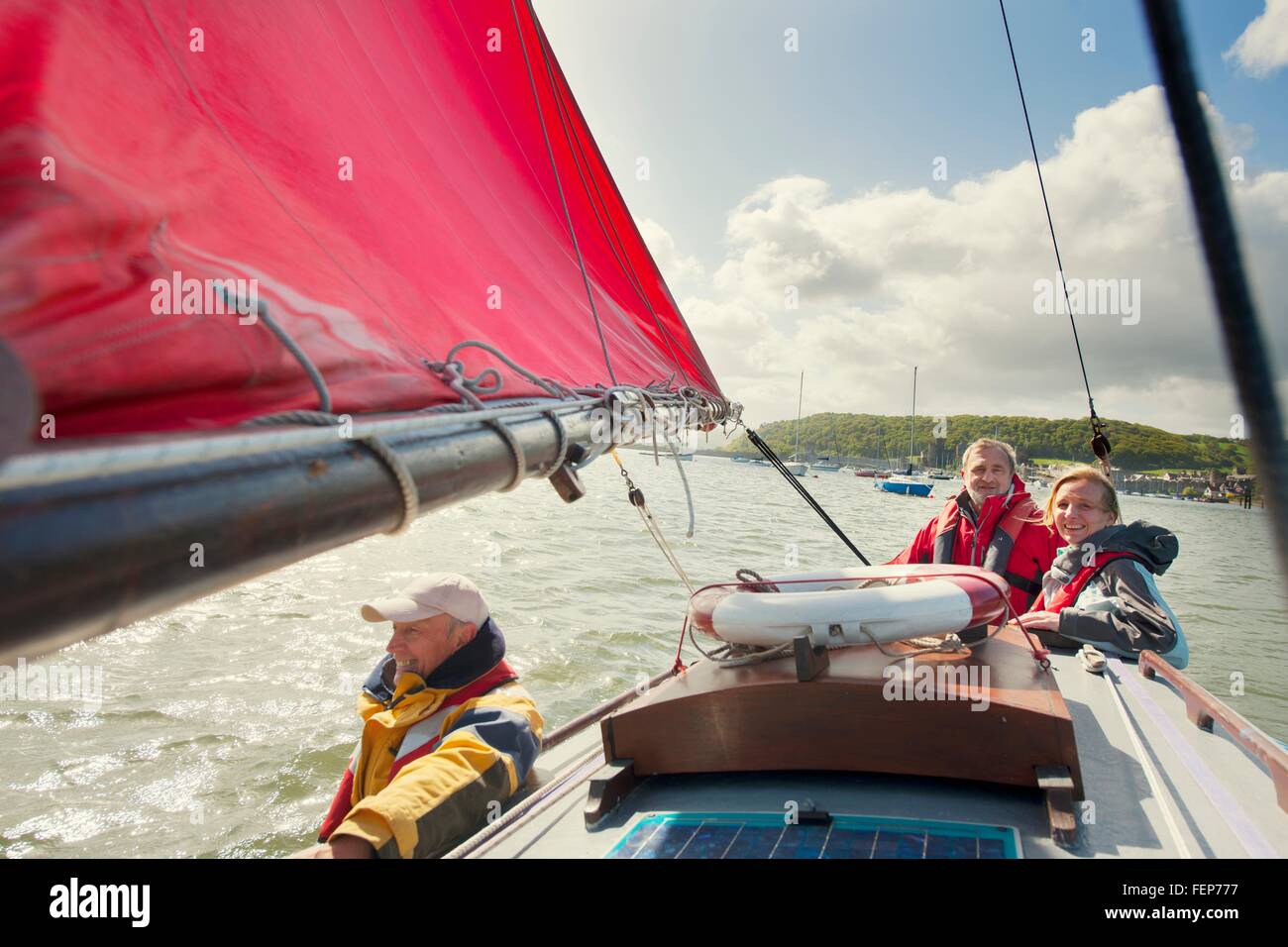 Small group of adults on sailing boat Stock Photo