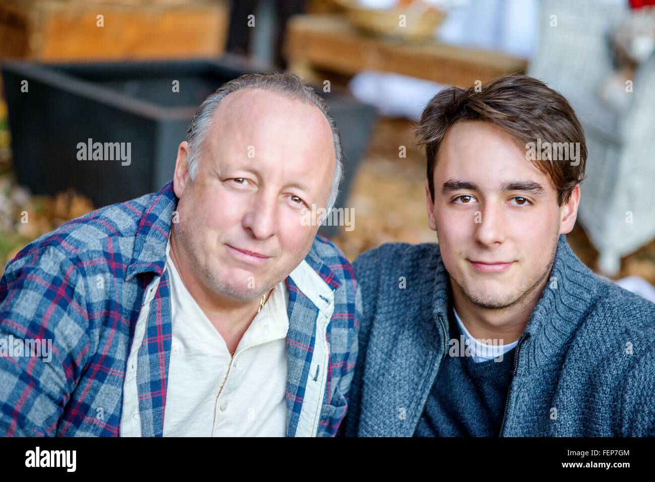 Portrait of mature man and adult son in garden Stock Photo