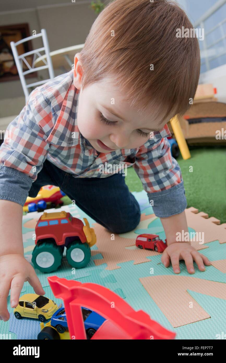 Baby boy playing with toys at home Stock Photo - Alamy