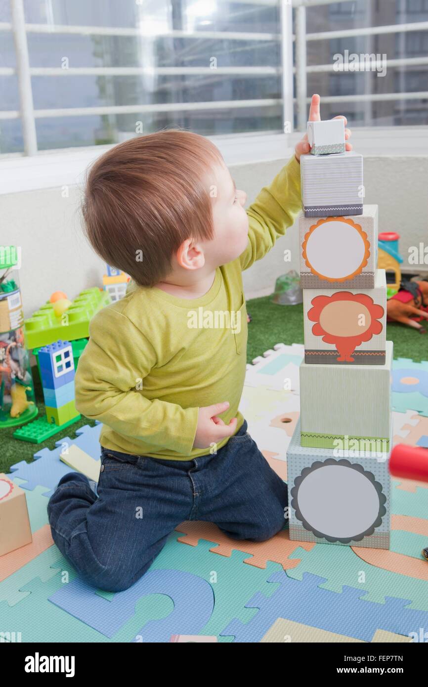 Baby boy stacking playing blocks at home Stock Photo