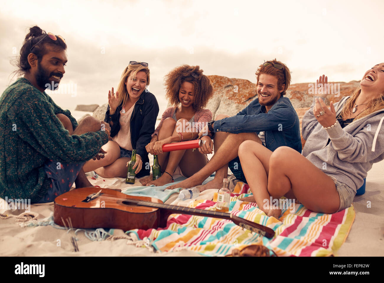 Group of young friends celebrating at a beach party together. Young people  having new year celebration at the seaside Stock Photo - Alamy