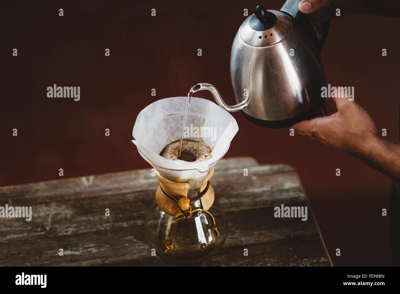 Man pouring water into filter coffee maker Stock Photo
