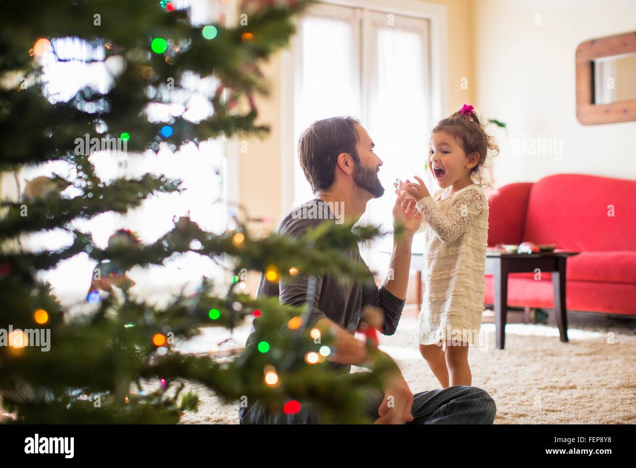 Father and daughter decorating christmas tree Stock Photo - Alamy