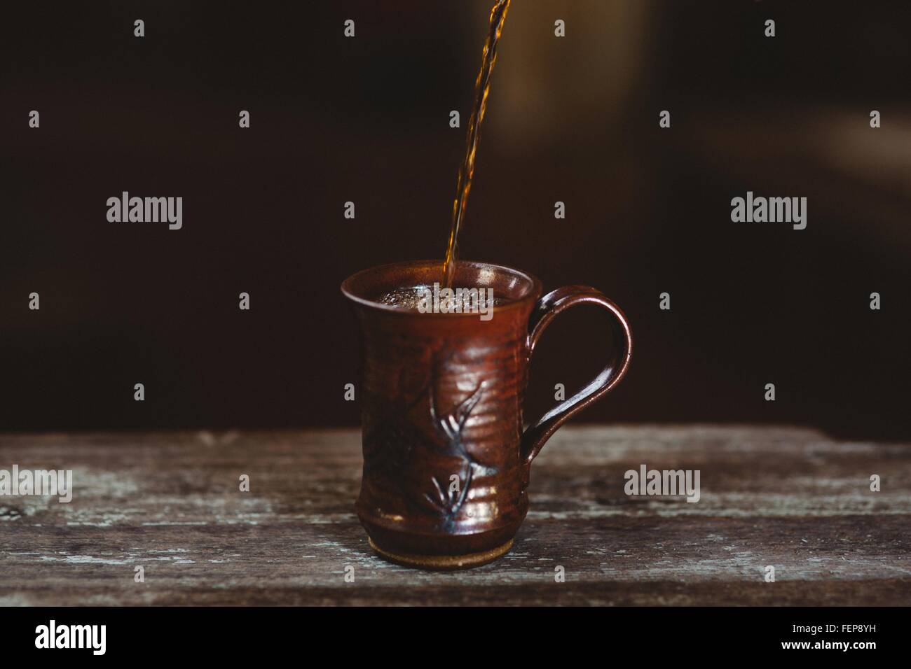 Coffee being poured into mug Stock Photo
