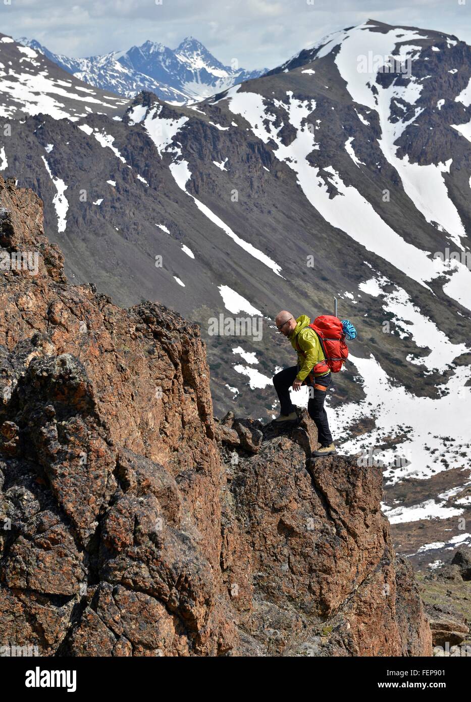 Male mountain climber climbing steep mountain, Chugach State Park ...