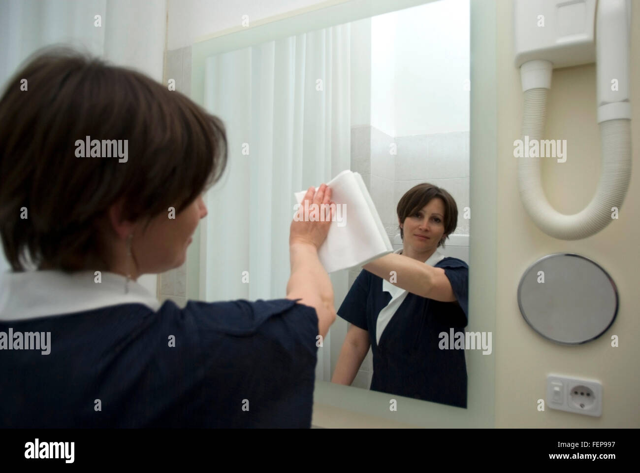 Maid working in hotel room Stock Photo