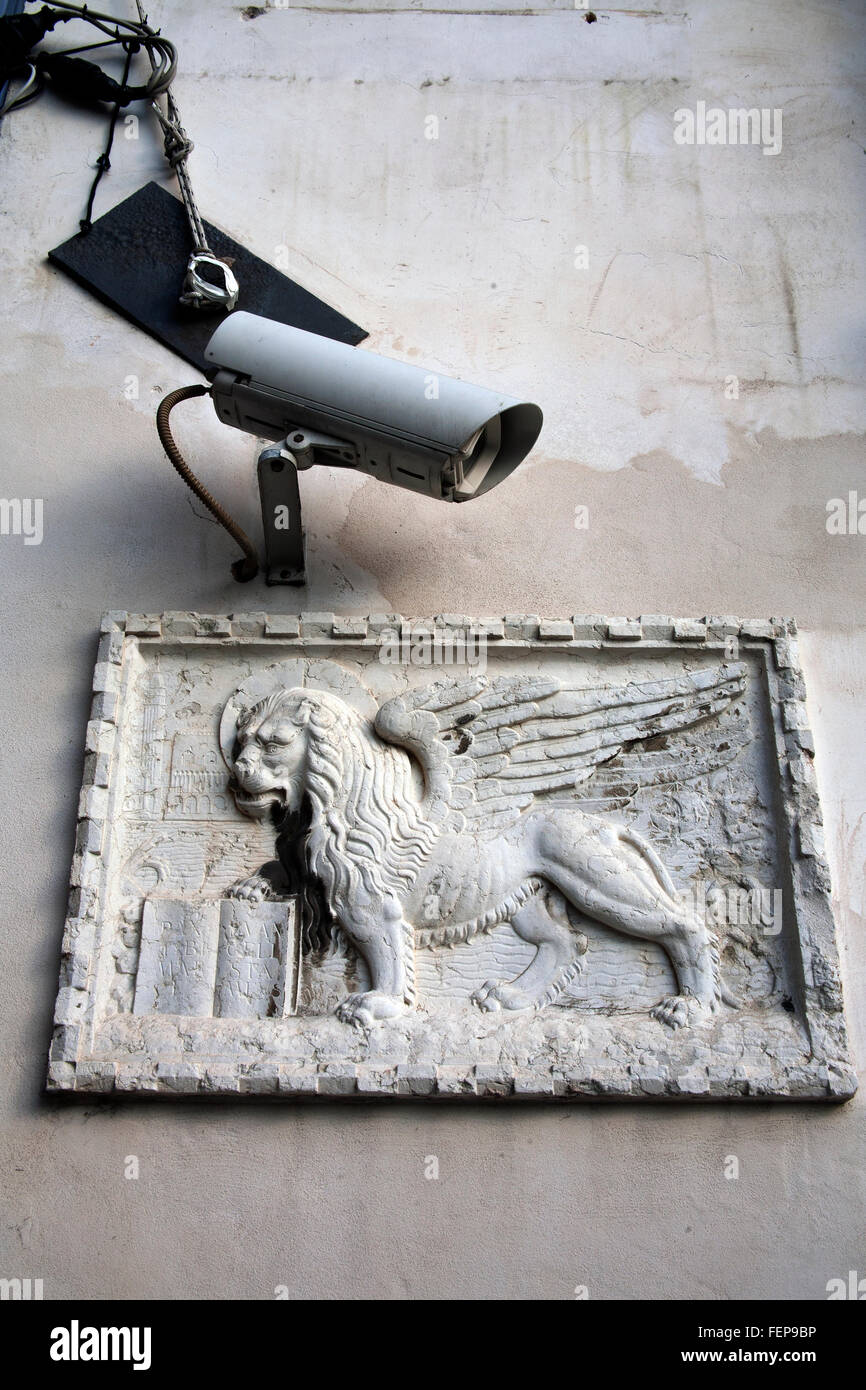 Venetian lion plaque the Lion of Venice - the symbol of Venice with a CCTV camera Italy Stock Photo